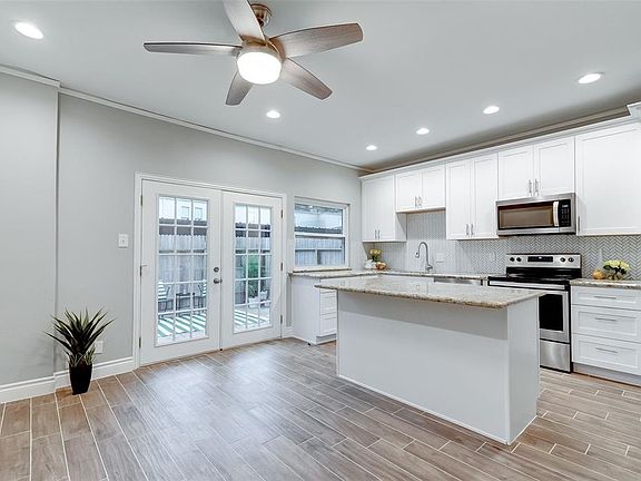 Gorgeous white kitchen with granite counter-top, herringbone white tile back-splash, brand new appliances, 42" cabinets, and a large pantry.