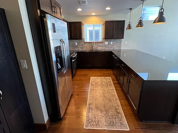 Stainless appliances, stone countertops, counter height seating