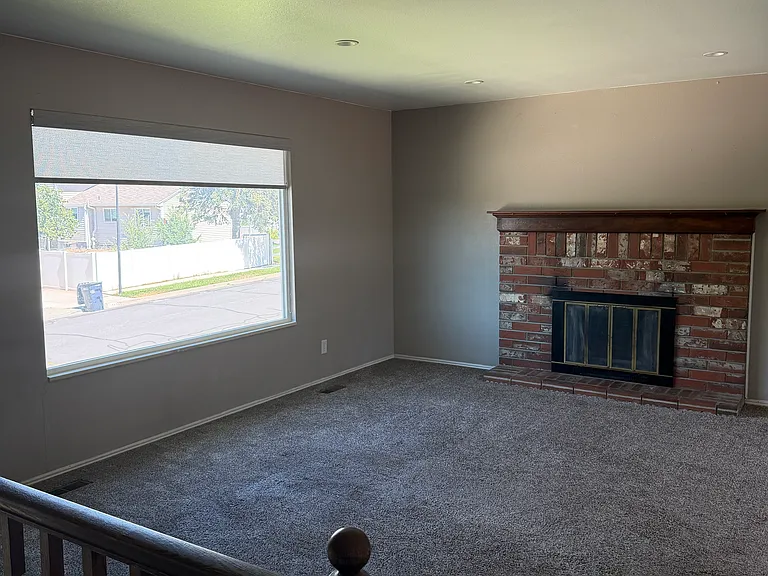 Upstairs living room with new paint & new window shades.