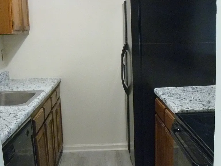 Kitchen from dining area. New counter tops, sink and faucet.