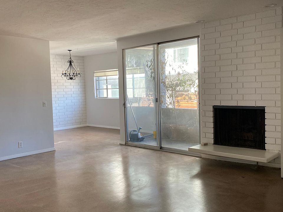 Open concept Living and Dining Rooms. Brick wall fireplace. Lots of natural light