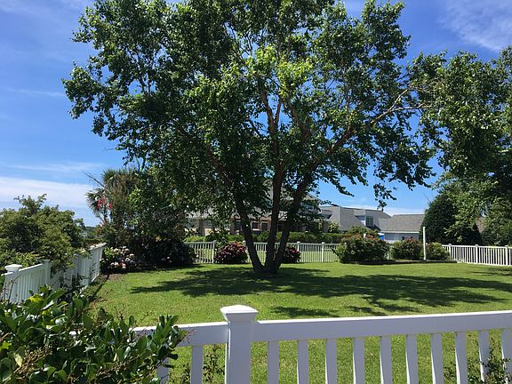 Fenced backyard with view of Bogue Sound