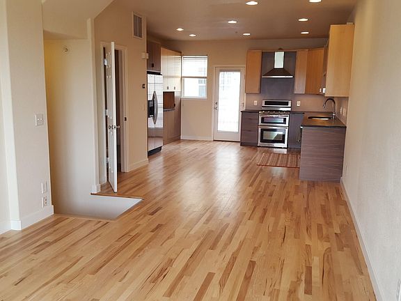 landing from downstairs at left, and door to powder room bath, then kitchen. As seen from living room