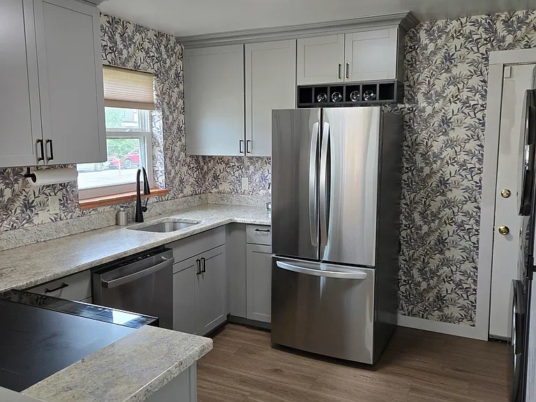 There are of new tall cabinets with crown molding and wine rack. Convenient back door leads to side wall to backyard.
All new high-end appliances:
LG 2 door / bottom draw refrigerator w/ice maker,