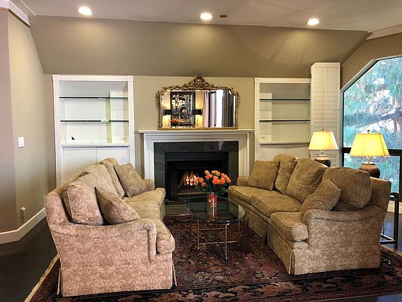 Wood burning fireplace with book shelves and storage below.