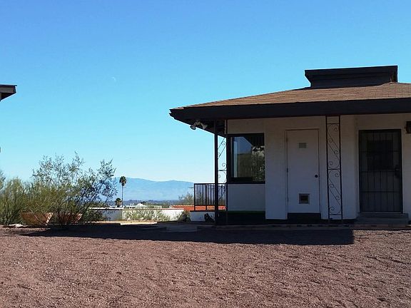 West view of house with covered parking