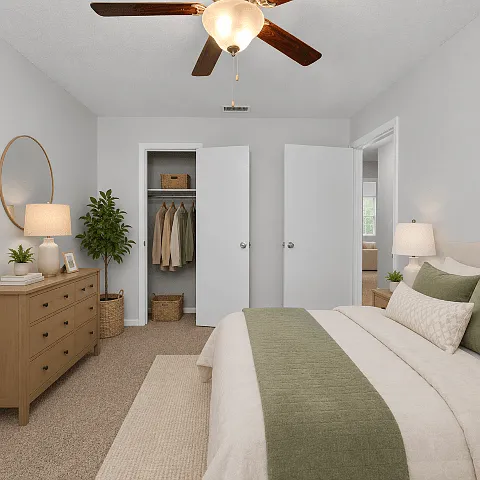 Bright bedroom with plush carpeting and room for a complete furniture set.