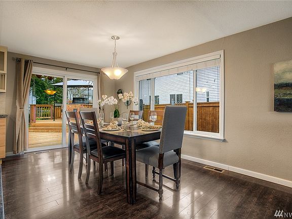 Spacious dining area with access via slider to custom back deck.