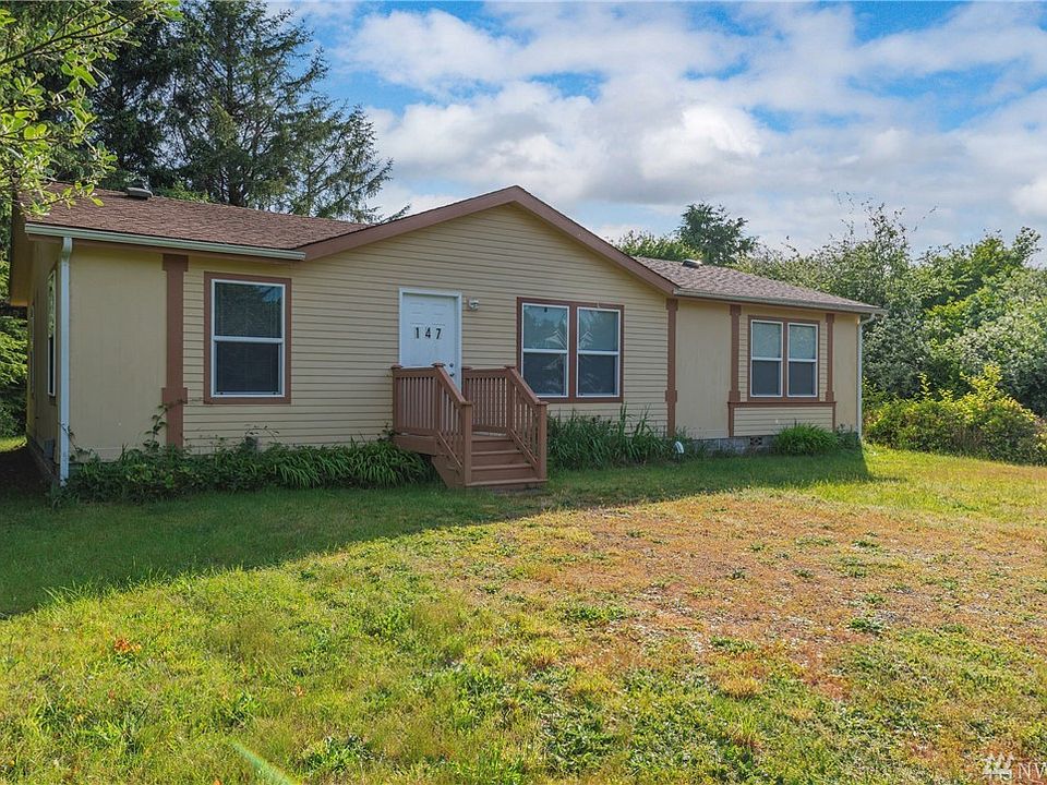 This lovely home is nestled among mature plantings. 