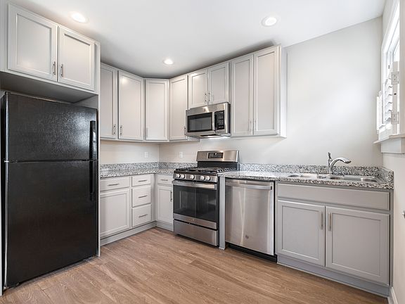 Kitchen with Stainless & Black Appliances with Granite Countertops