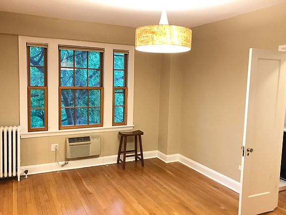 Living area with entrance to bathroom and walk-in closet on right.