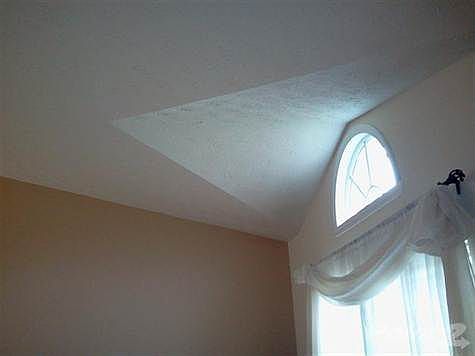 Living room is bright with natural light.  Walls are freshly painted and neutral.