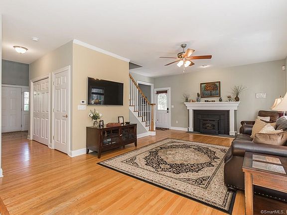 The first floor of the home has an open floor plan with the family room being adjacent to the kitchen and eat-in area. Hardwood floors and high ceilings are throughout the home. Please note the fireplace and the front foyer at the left of the picture.