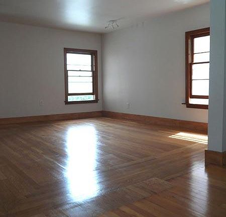 Spacious, sunny living area with hardwood floors