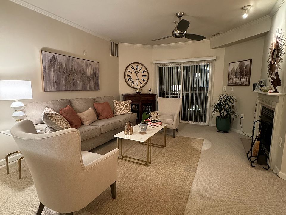 living room with fireplace and sliders to balcony