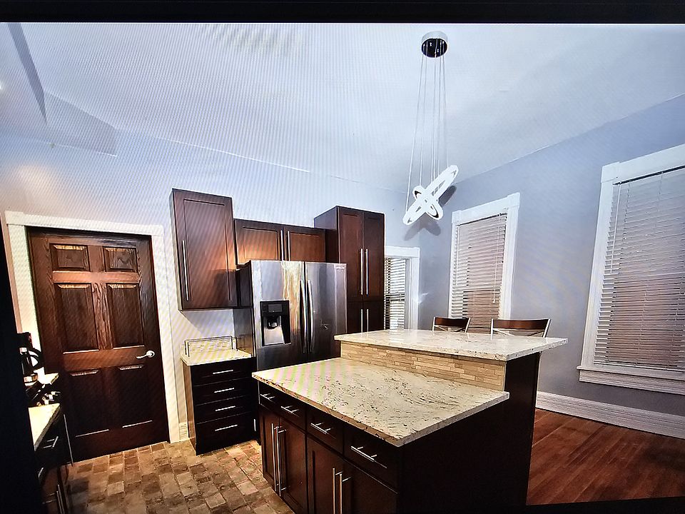 High ceiling New York style brick flooring in the kitchen part area.