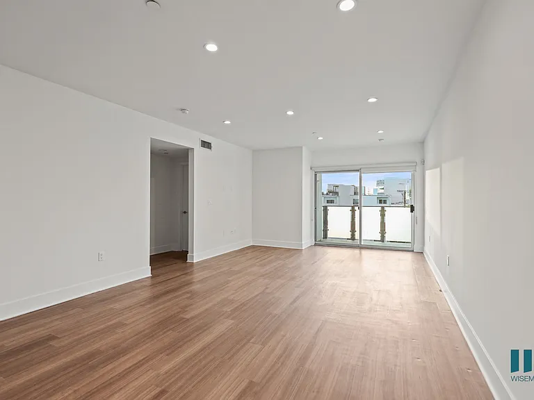 Open-Concept Dining, Living Room, and Patio with Recessed Lighting and Vinyl Flooring