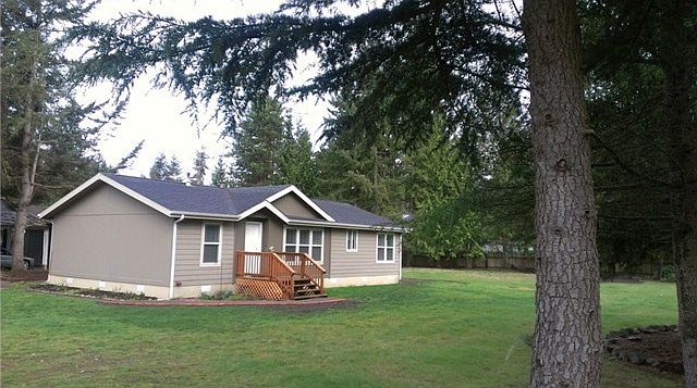 Nearly new mfg home on two fenced acres, lawns & fields, tall tr