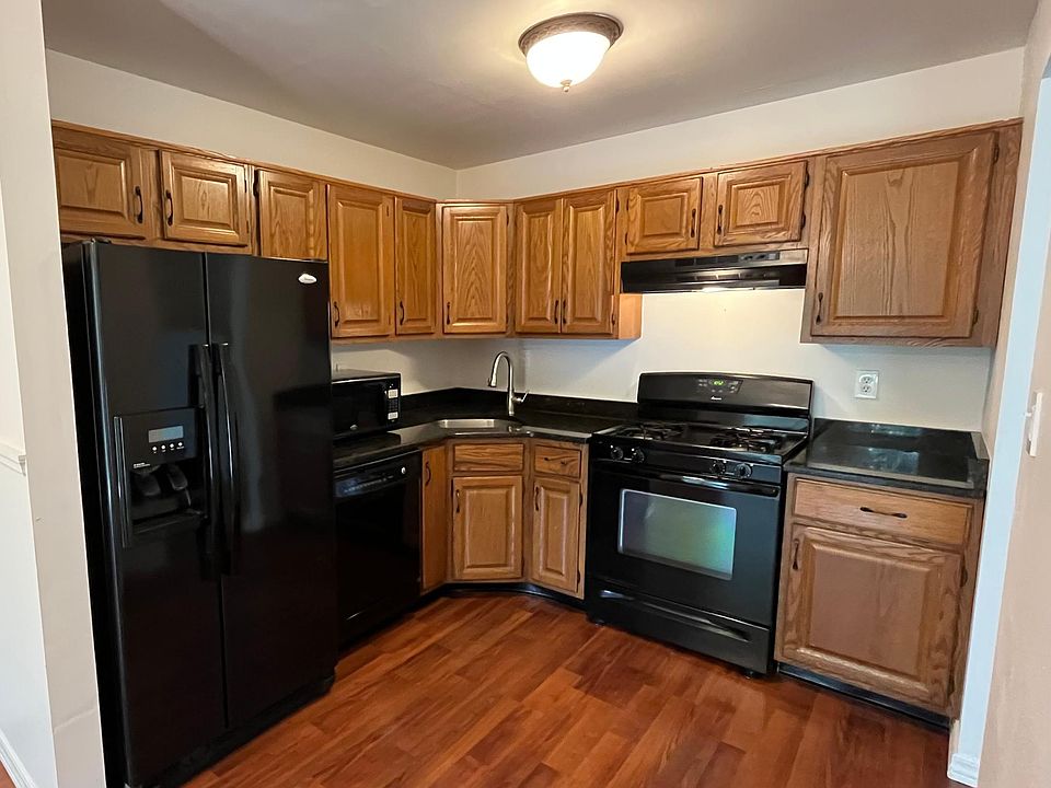 Updated kitchen with granite countertops & stainless steel sink.