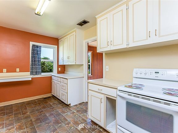 Galley kitchen, showing the door to the dining room.