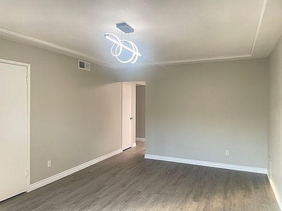 Spacious living room with modern lighting.