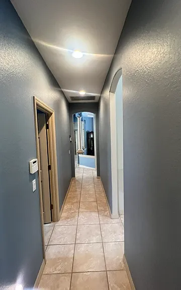 Hall from bedroom #2-3 with access to the laundry area, kitchen and primary bedroom wing. A true 3 way split Florida home.