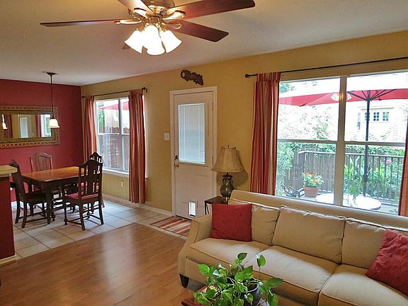 Wood laminate floors in the living room blend to tile in the kitchen and breakfast room.