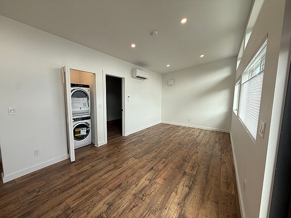 Washer and dryer in a separate closet in the main room.