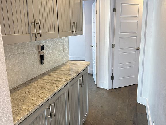 Hallway from kitchen leading to the 3 bedrooms