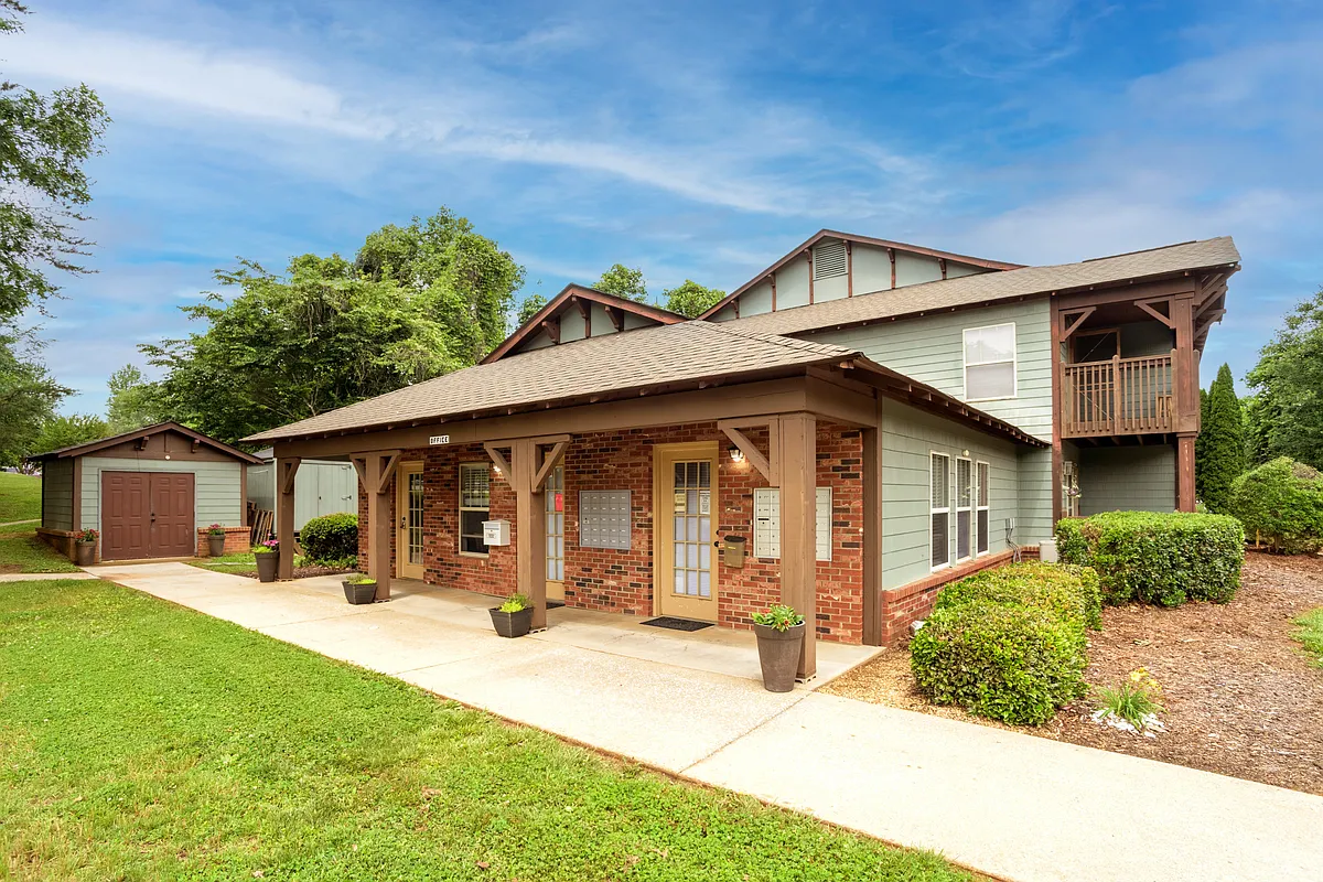 A charming, well-maintained leasing office nestled in lush greeneryyour hub for friendly, on-site management and easy access to assistance. - Spaulding Woods I Apartments
