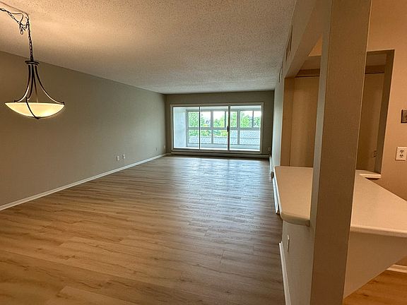 Unit has open floor plan with a enclosed porch, dining room and living room off of the kitch.