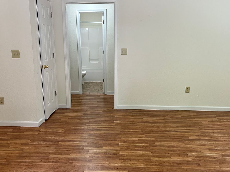 View through front door - living room area to the right and full kitchen to the left - straight ahead a full bath and one bedroom to the left and one to the right