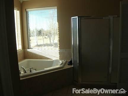 master bath in owners suite
						:
						large corner jetted tub with seperate shower - 2 walk in closets in master