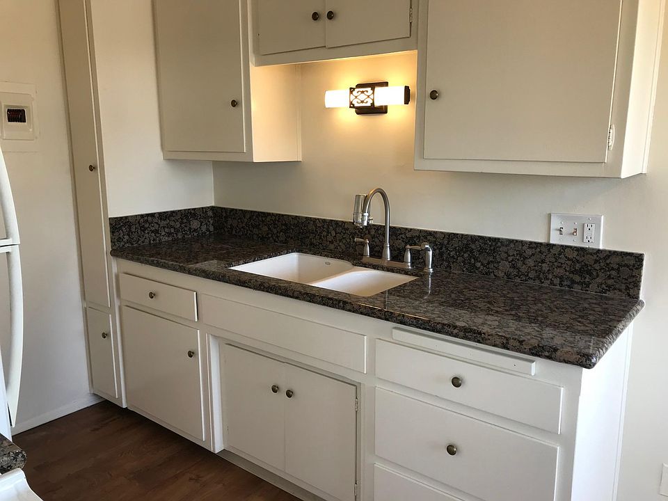 Completely remodeled Kitchen: new granite countertops, porcelain sink, new fixtures, and a great deal of storage space.