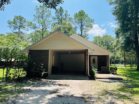 Space in carport for one vehicle, and ample parking in front of carport.