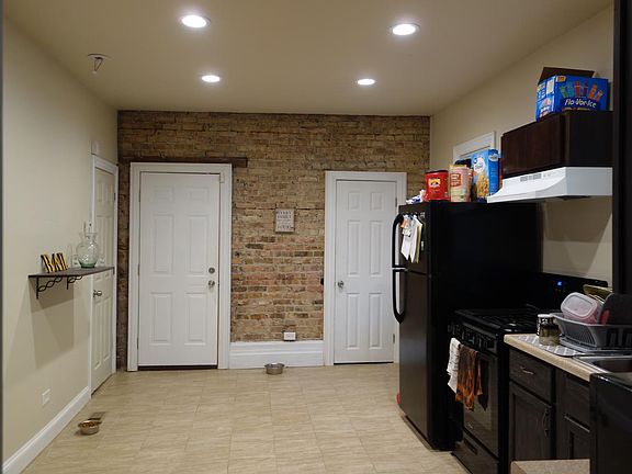 kitchen with exposed brick wall