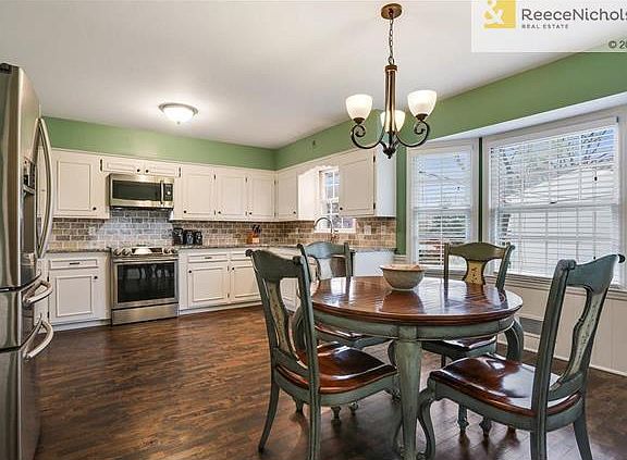 Large eat in kitchen features granite countertops and stainless appliances.