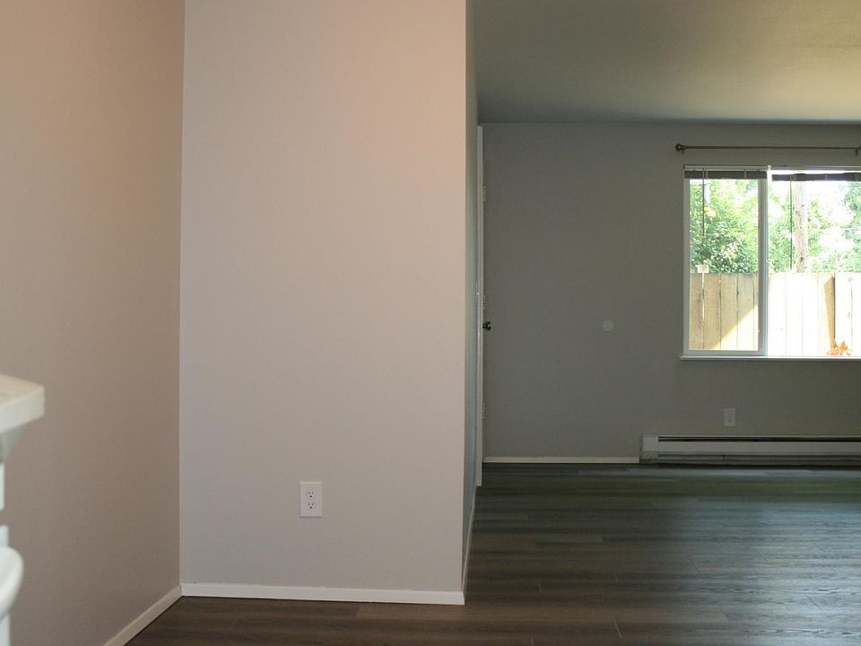 Dining Area with Ceiling Fan and Open Floor Plan to Living Room