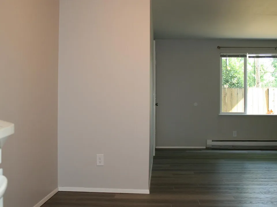 Dining Area with Ceiling Fan and Open Floor Plan to Living Room
