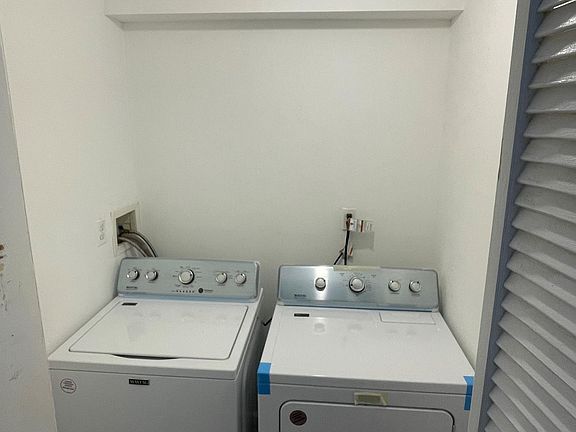 New washer and dryer in a closet within the unit.