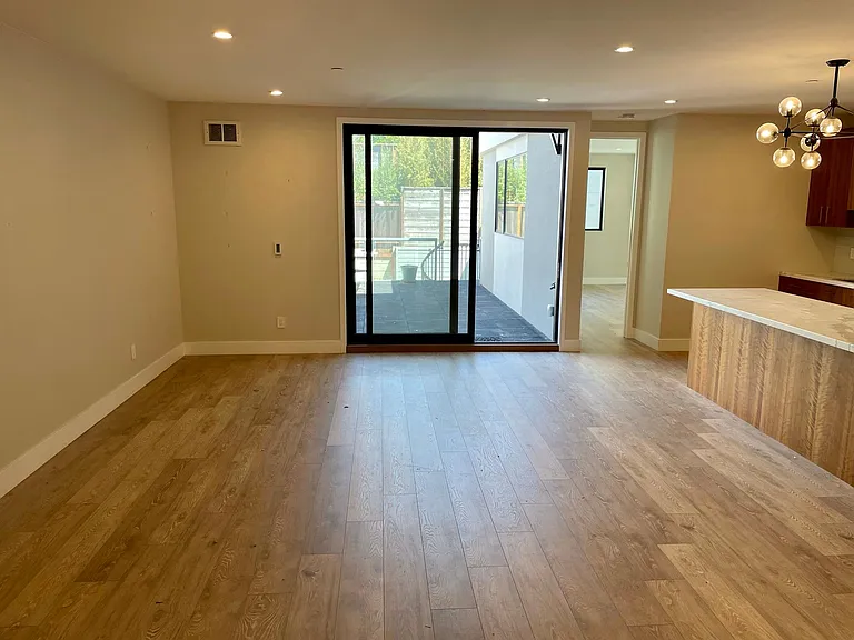 Deck from Living room, huge kitchen island to the right