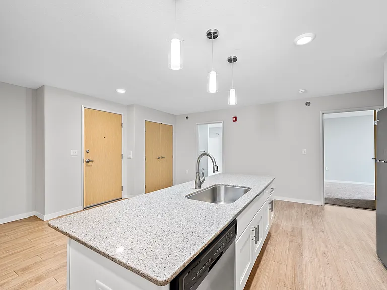 Modern kitchen with sleek countertops, stylish lighting, and stainless steel appliances, offering a bright and open layout. Modern kitchen with sleek countertops, stylish lighting, and stainless steel appliances, offering a bright and open layout.