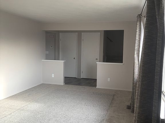 Living room with view to entryway coat closet