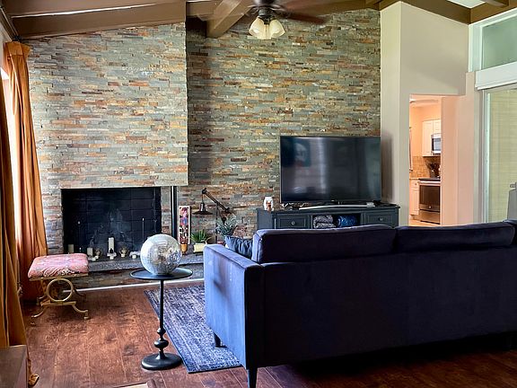 Family room with non working fireplace and large stone accent wall