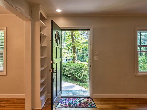 Enter into living room with two built in bookcases.