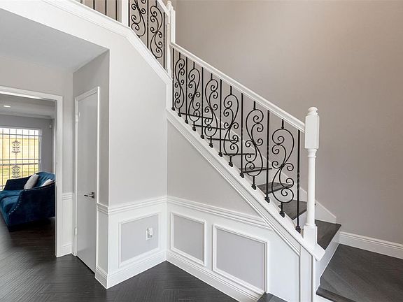 Wrought iron accents and tile laid in a herringbone pattern are stunning against the quiet, neutral color palette...