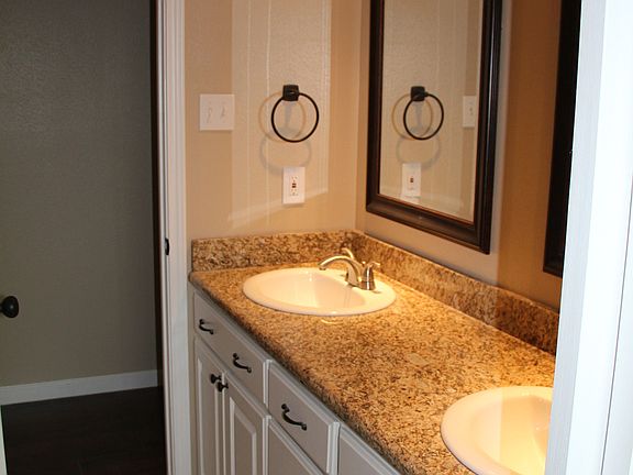 Hall bathroom with tub and double sinks
