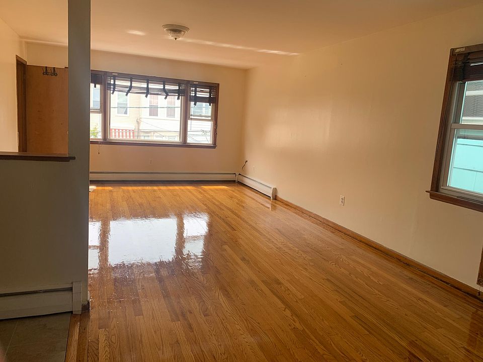 living room with one main window and side window. living room has a walk-in closet.