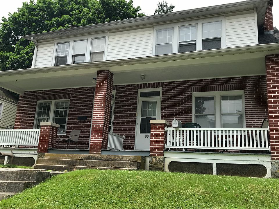 Street view of the front of the house. 33 N Prince is on the right of the duplex. The front porch has plenty of space to relax and space for seating. Front door as well as back door access off of the yard/driveway.