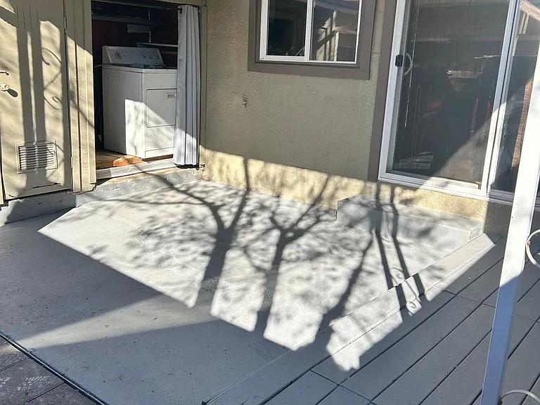 washer and dryer connection outside in patio area.